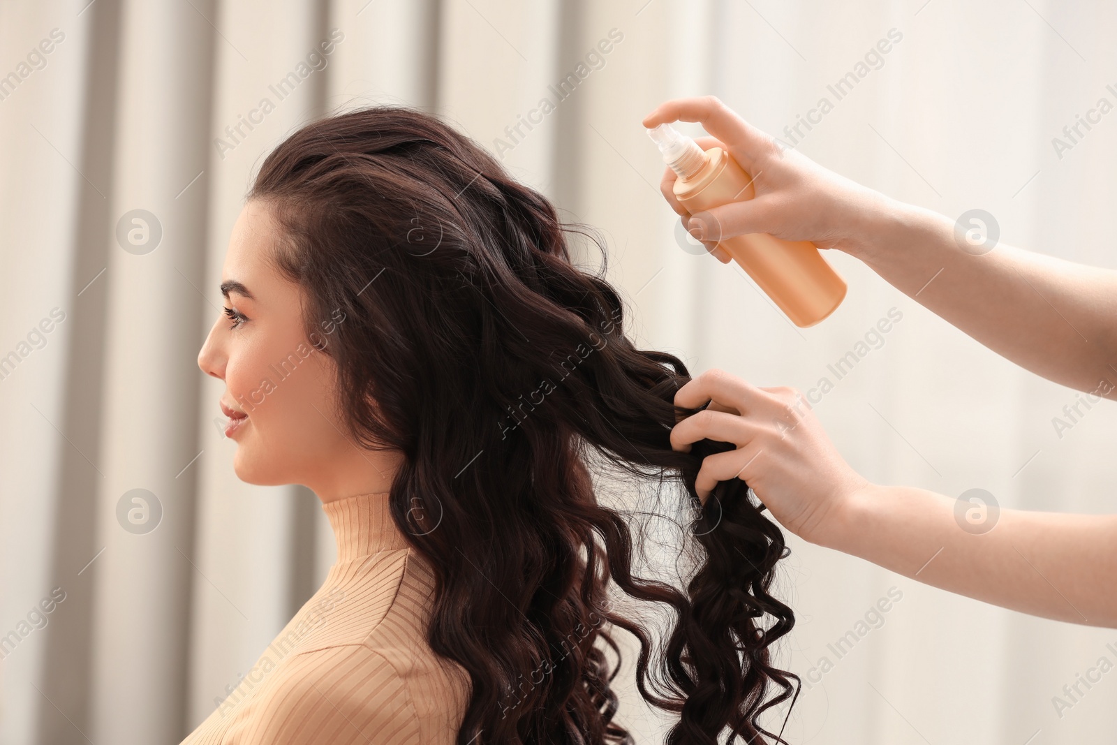 Photo of Hair styling. Professional hairdresser working with client indoors, closeup