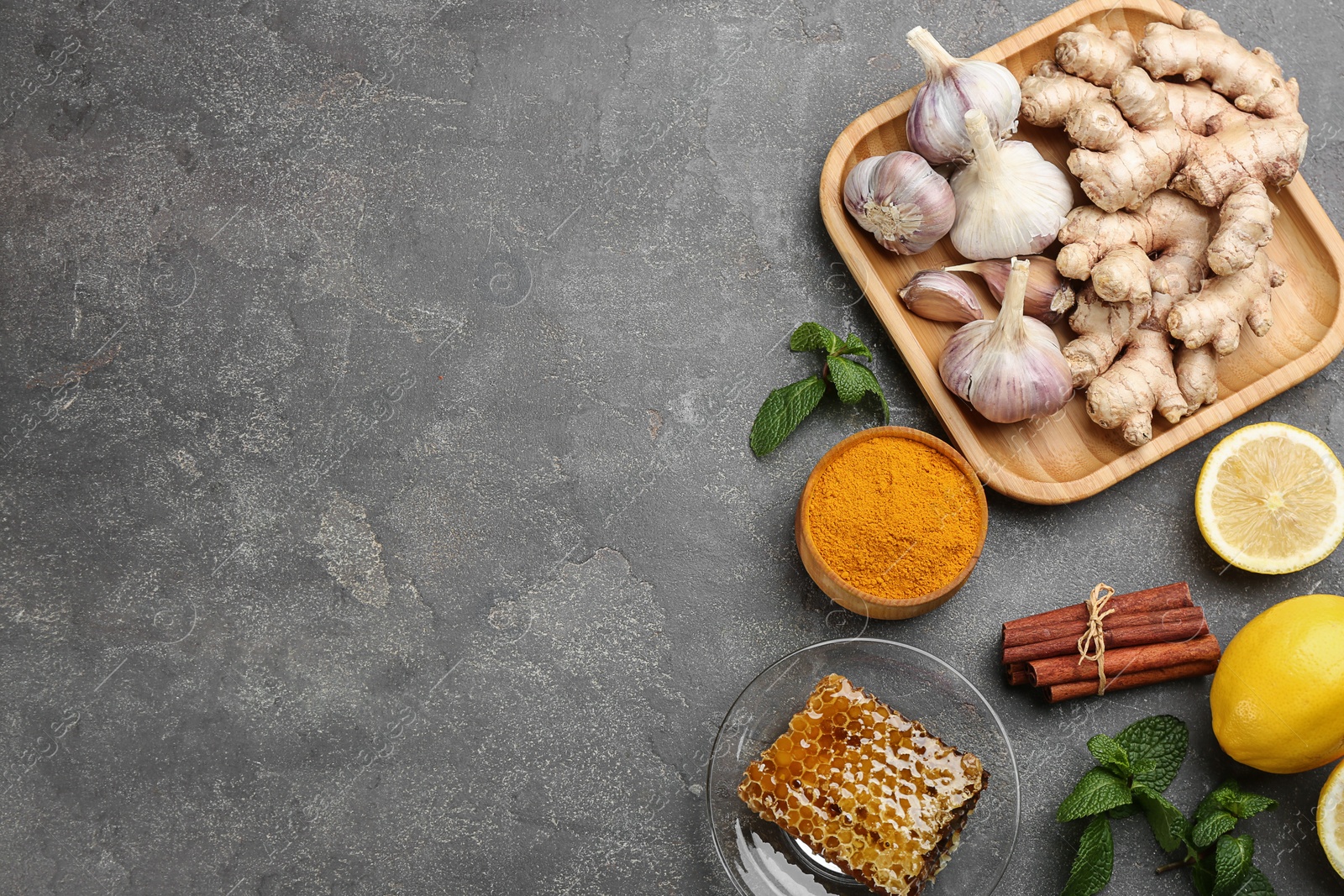 Photo of Flat lay composition with fresh products on grey table, space for text. Natural antibiotics