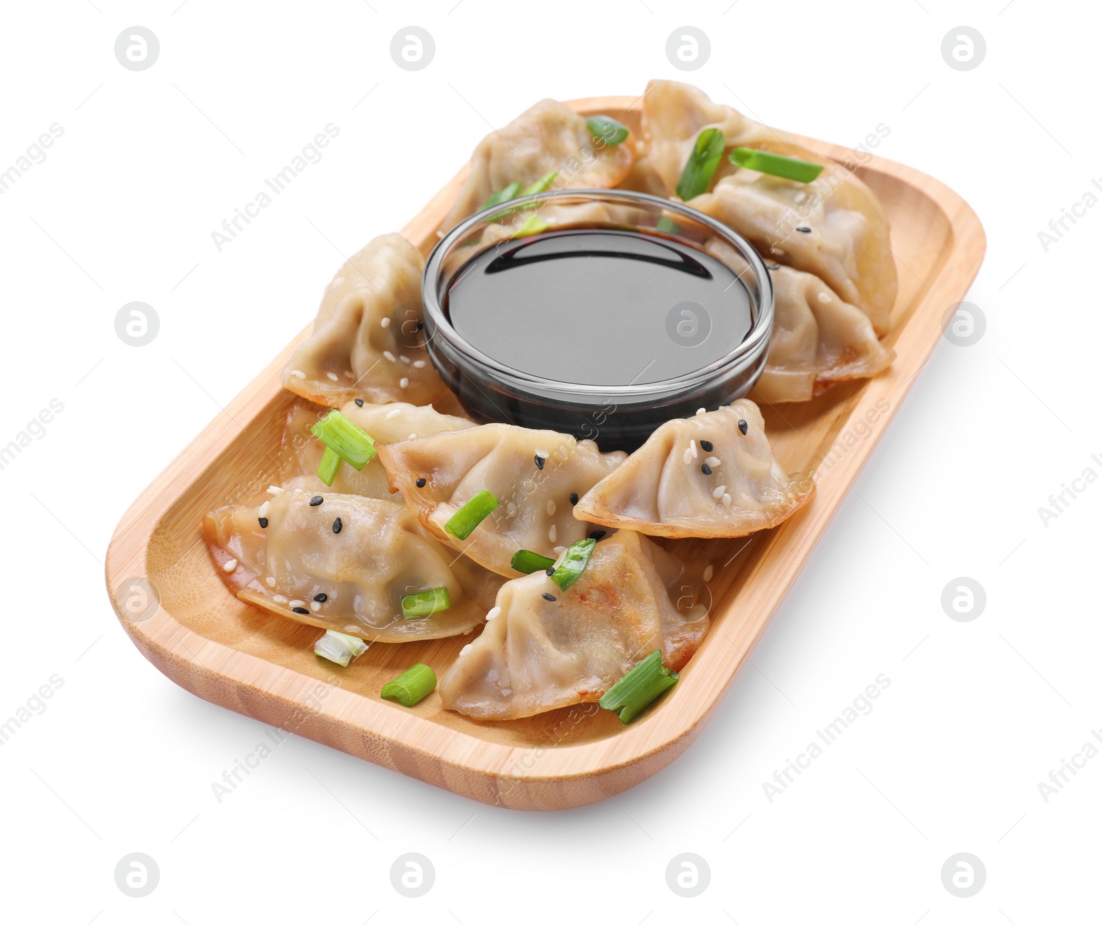 Photo of Delicious gyoza (asian dumplings) with green onions and soy sauce isolated on white