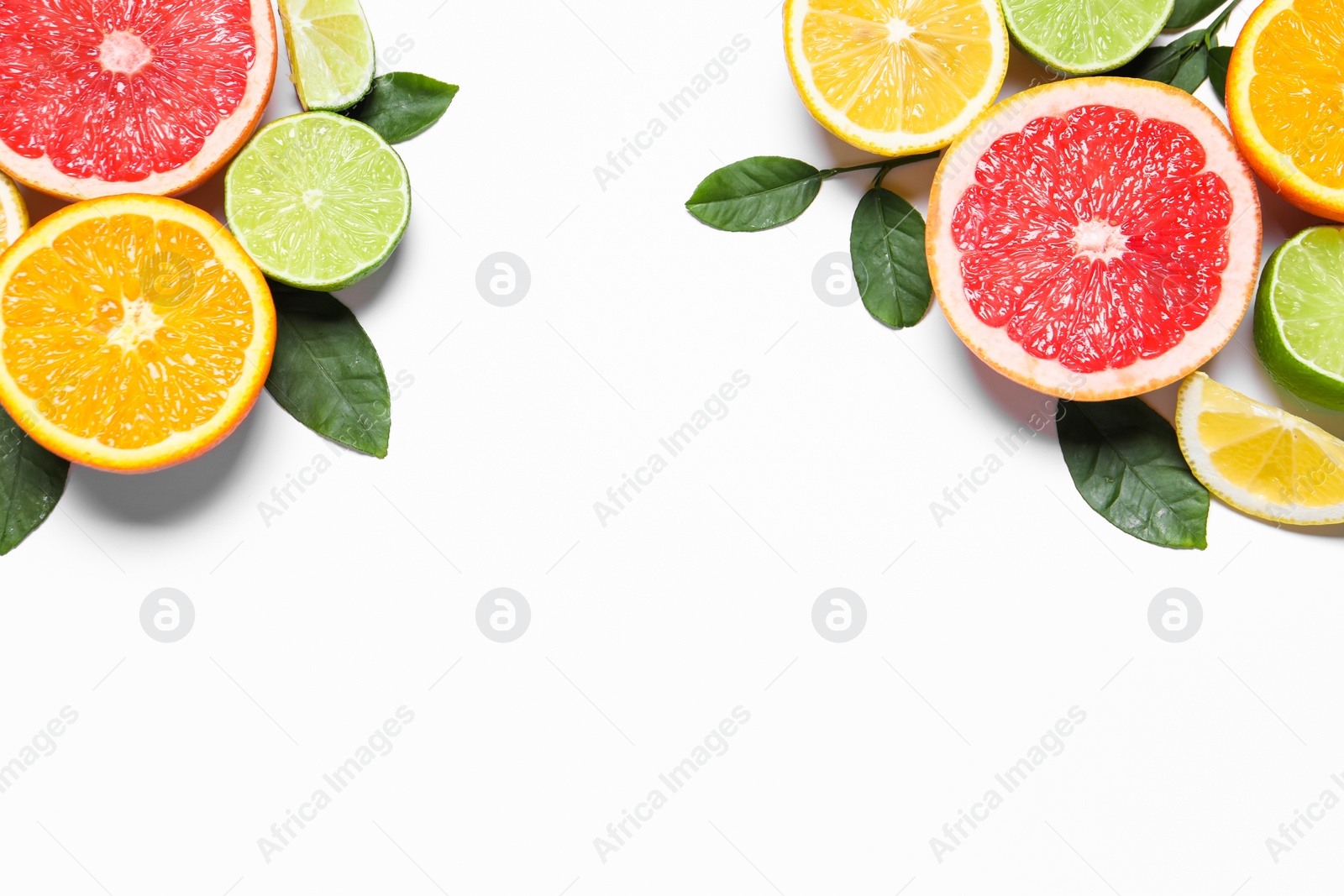 Photo of Different cut citrus fruits and leaves on white table, flat lay. Space for text