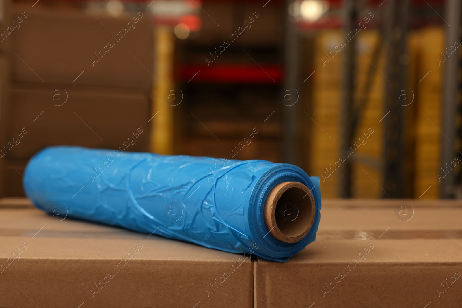 Photo of Roll of stretch wrap on boxes in warehouse