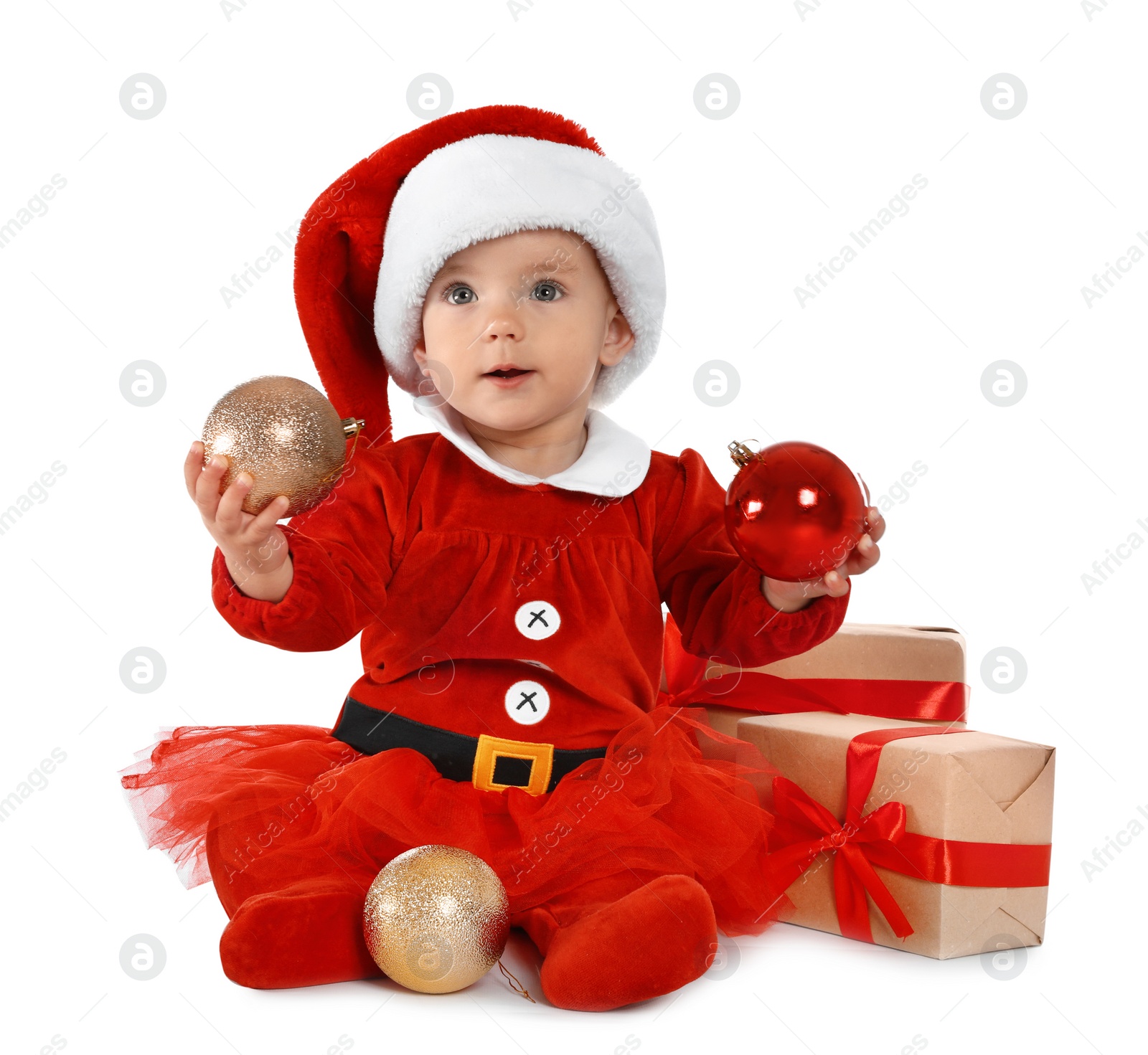 Photo of Festively dressed baby with gift boxes on white background. Christmas celebration