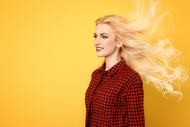 Photo of Portrait of young model with beautiful  hair on color background