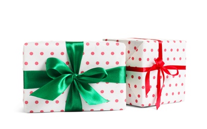 Photo of Beautifully wrapped gift boxes on white background