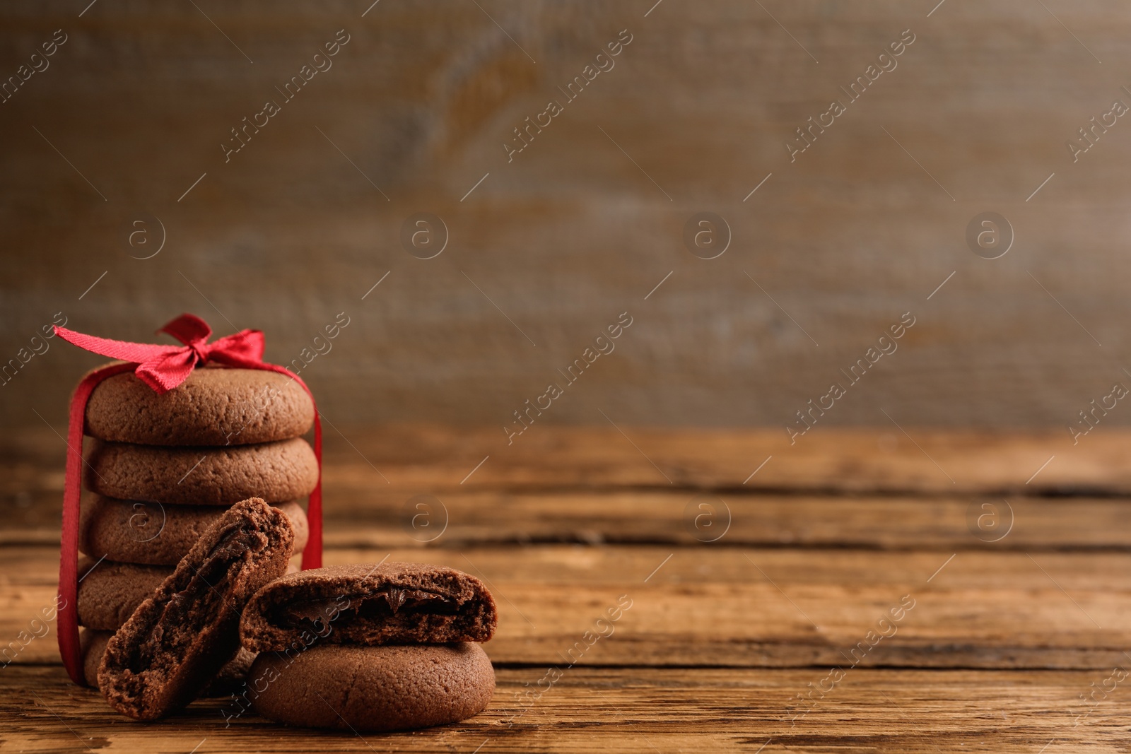 Photo of Tasty homemade chocolate cookies on wooden table. Space for text