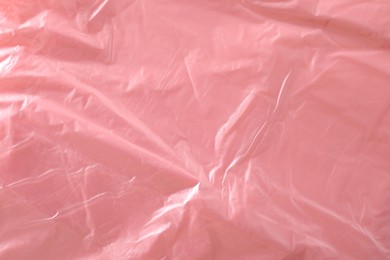 Texture of coral plastic bag as background, closeup