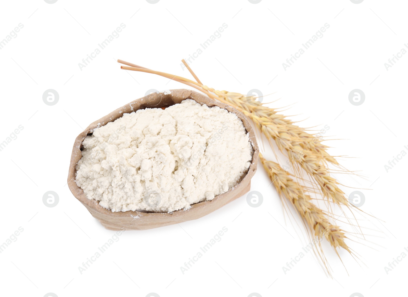 Photo of Paper bag with wheat flour and spikes isolated on white, top view