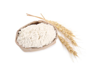 Photo of Paper bag with wheat flour and spikes isolated on white, top view