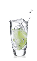 Photo of Lime slice falling into shot glass of vodka on white background