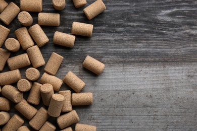 Wine bottle corks on wooden table, flat lay. Space for text