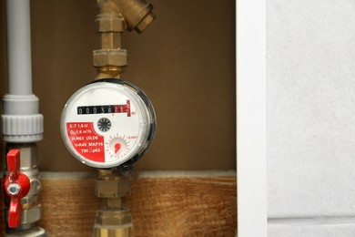 Photo of Electric meter in fuse box, space for text. Water measuring device