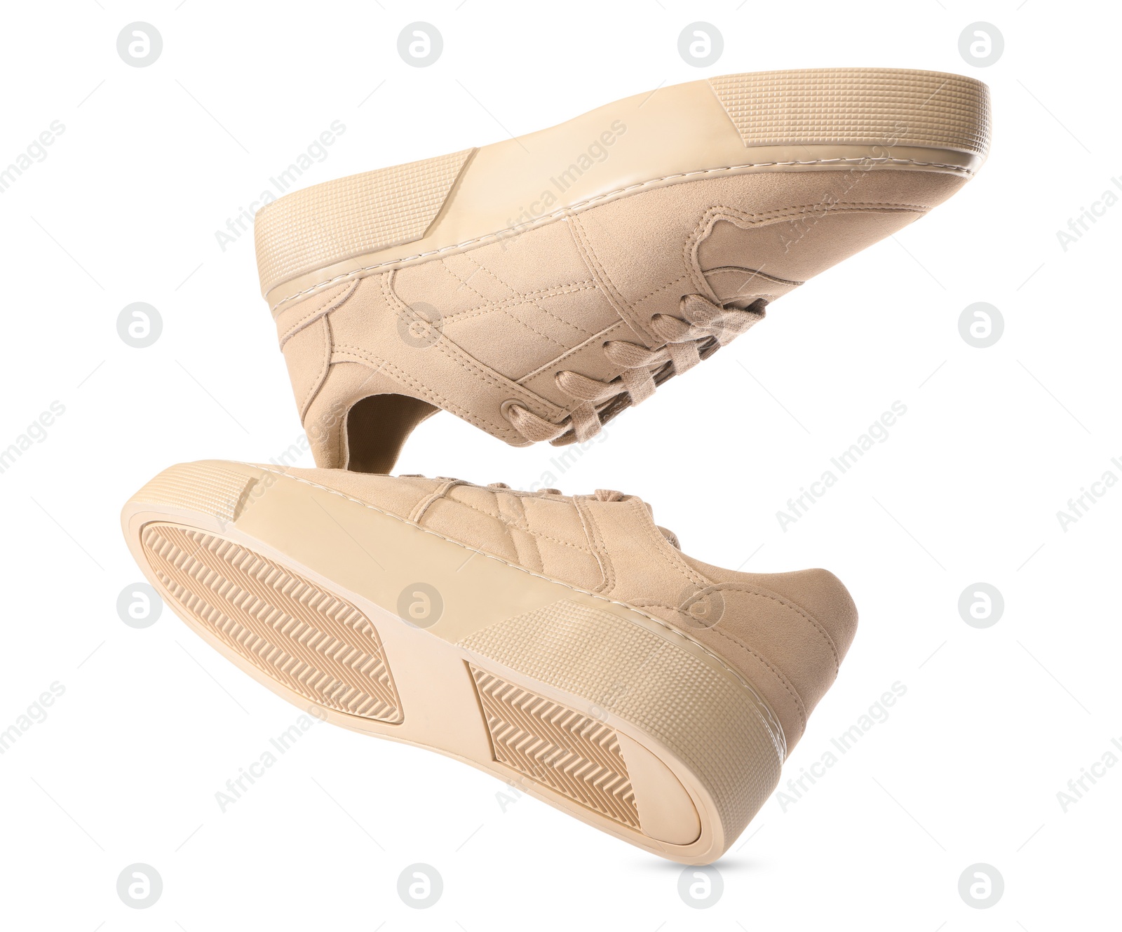 Photo of Pair of stylish beige sneakers isolated on white