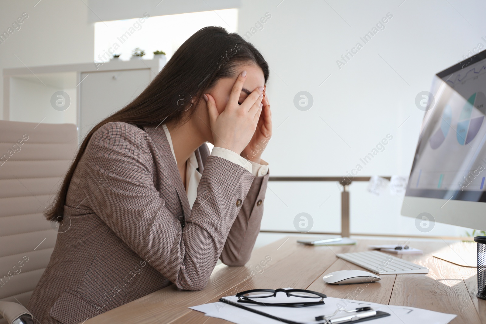 Photo of Businesswoman stressing out at workplace in office