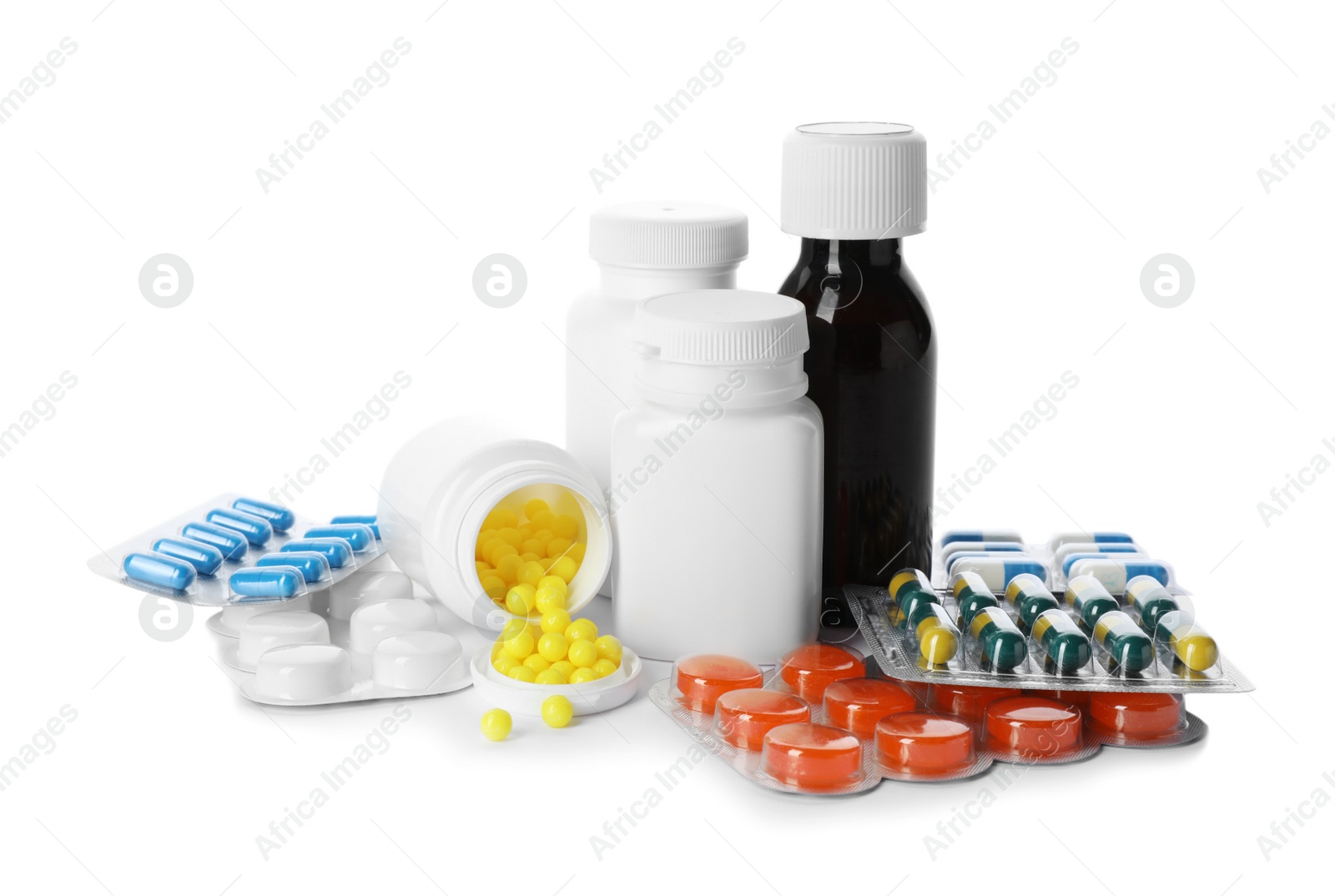 Photo of Bottle of cough syrup and different pills on white background