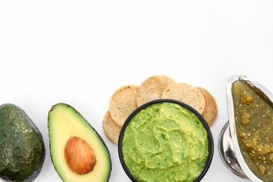 Photo of Delicious guacamole made of avocados and nachos on white background, top view