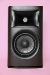 Photo of One wooden sound speaker on pink background