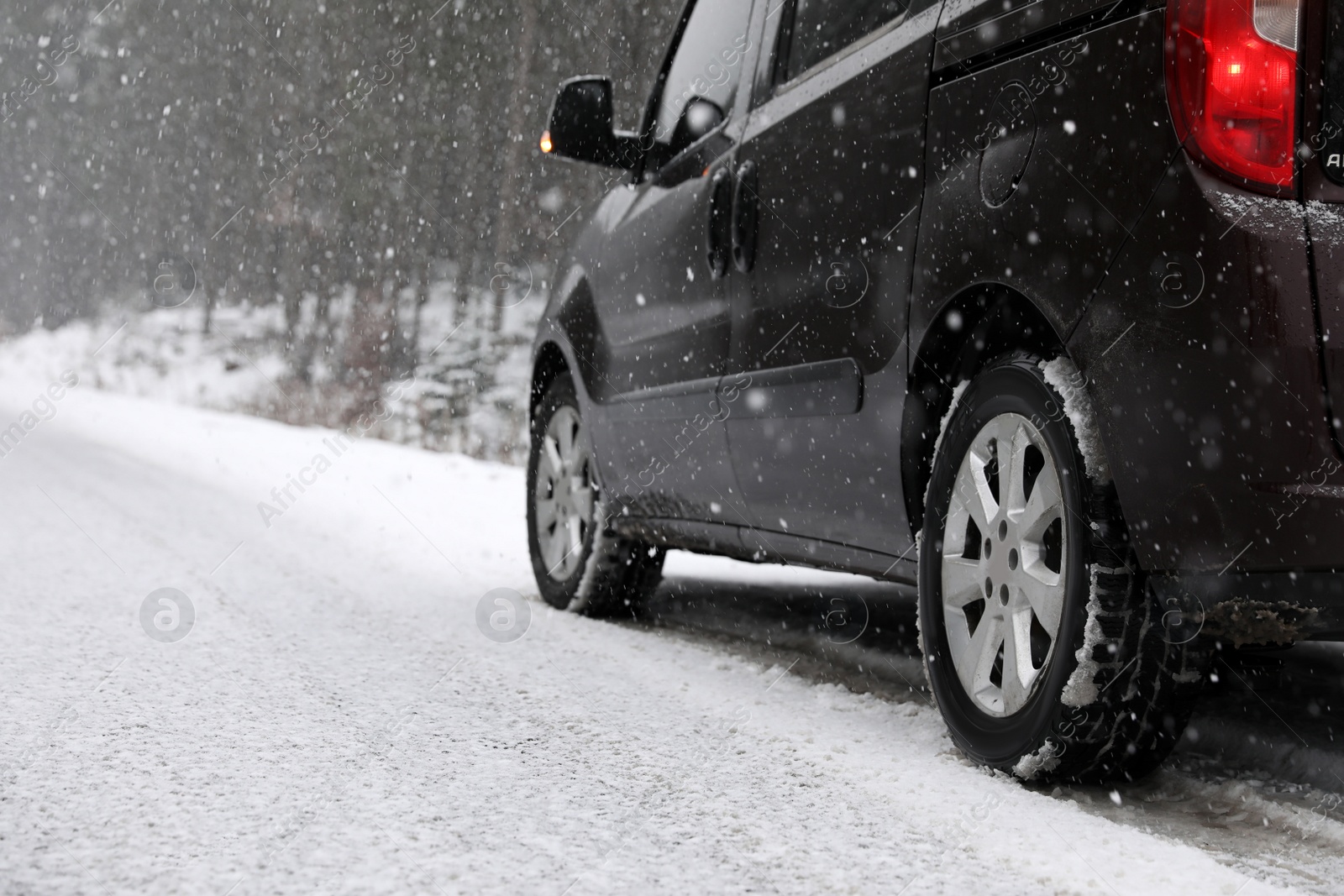 Photo of Country road with car on snowy winter day. Space for text