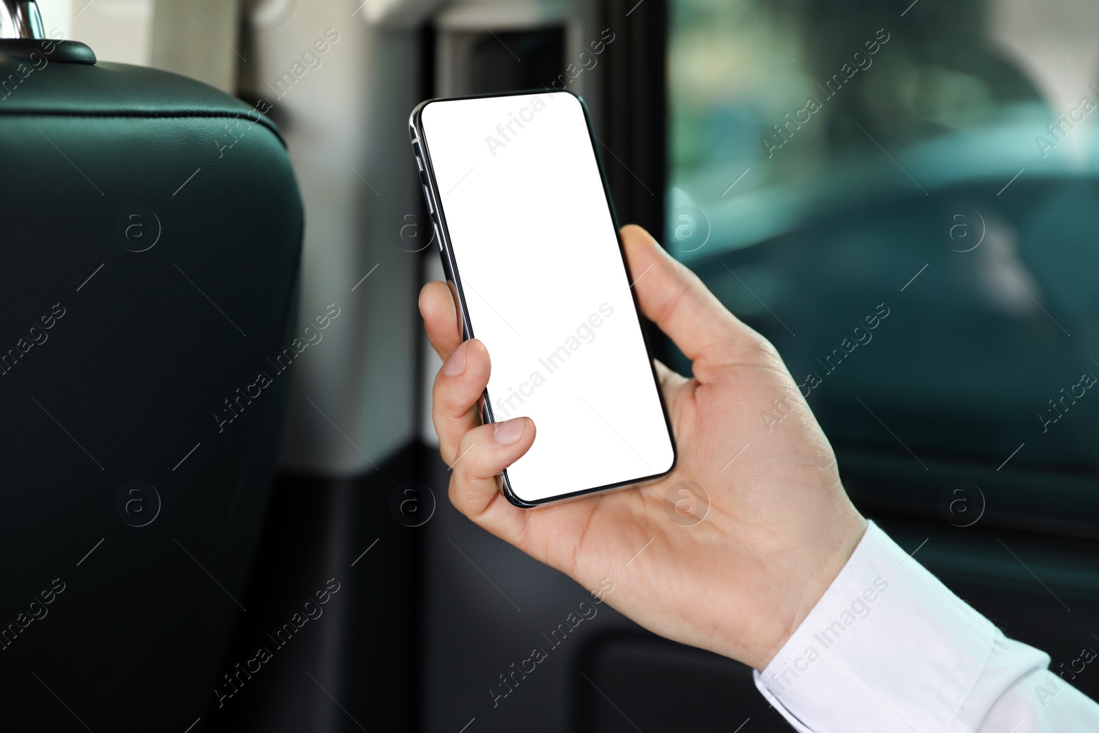 Image of Man holding mobile phone with empty screen in auto salon, closeup