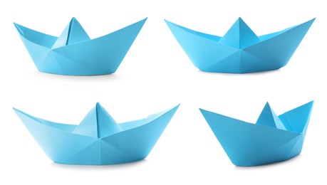 Image of Set with light  blue paper boats on white background