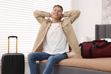 Smiling guest stretching in stylish hotel room