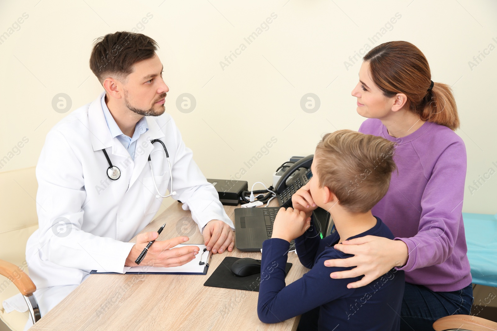 Photo of Woman with her child visiting doctor in hospital