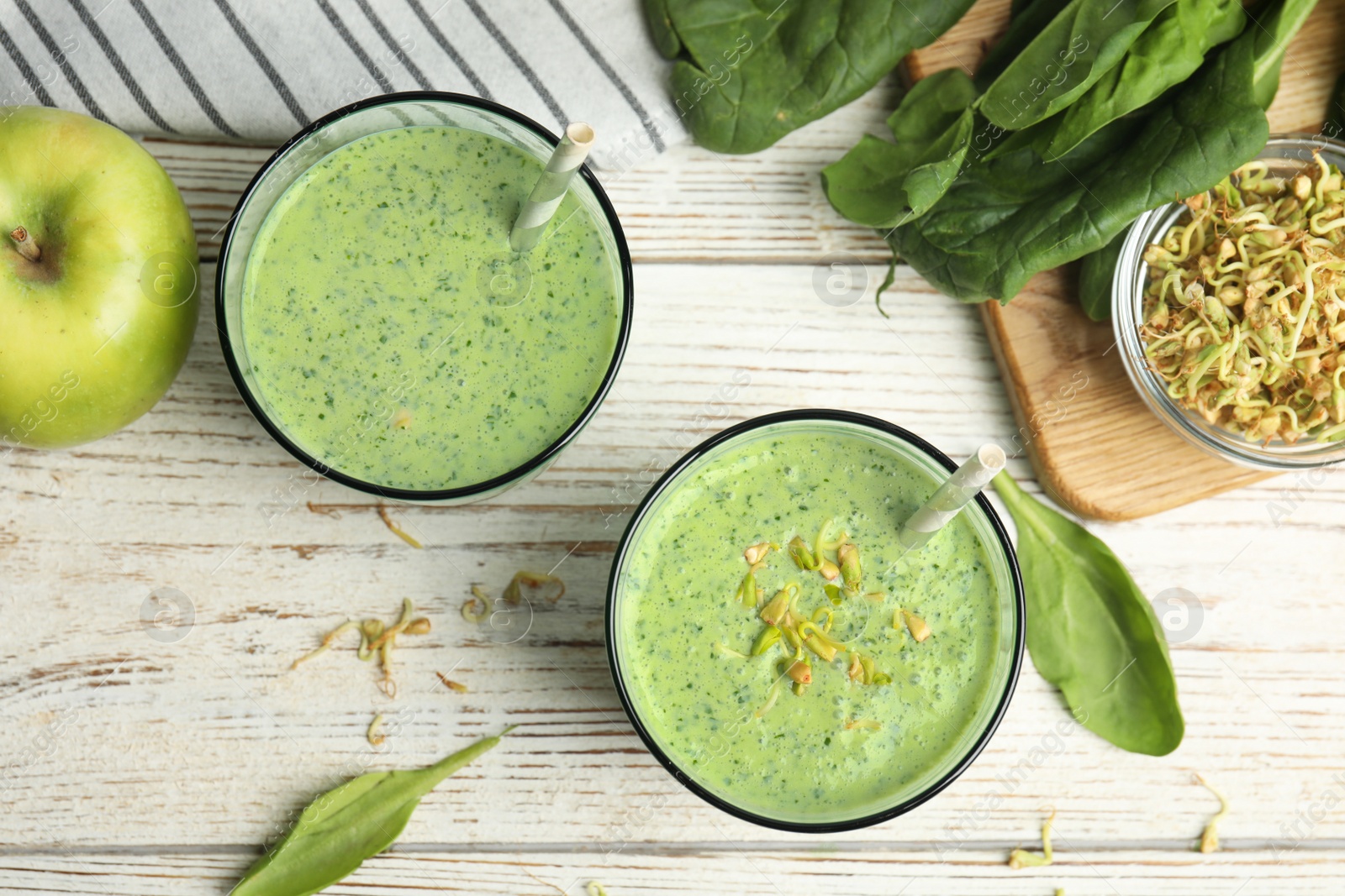 Photo of Flat lay composition with green buckwheat smoothie on white wooden table