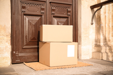 Delivered parcels on door mat near entrance