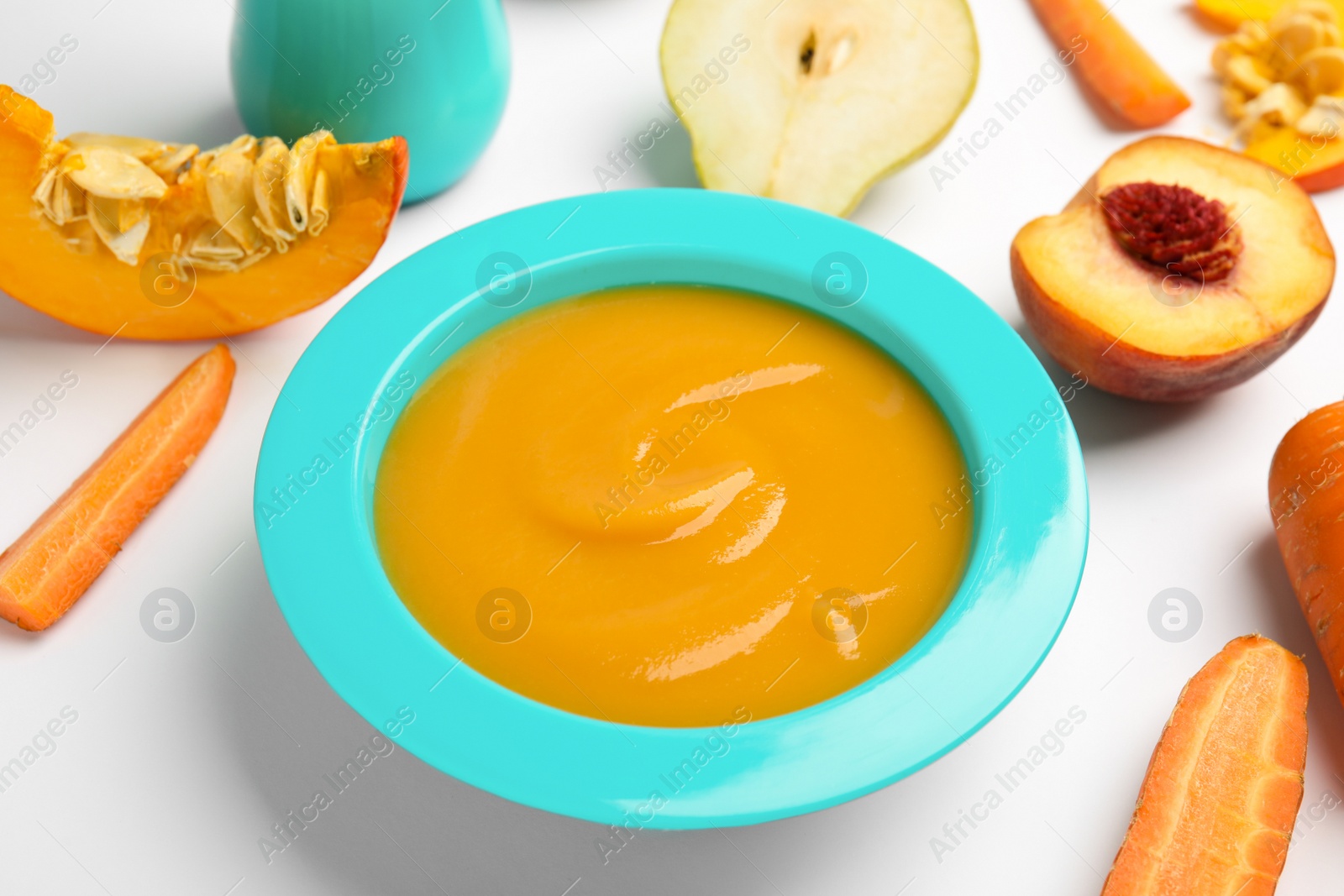 Photo of Healthy baby food and ingredients on white background, closeup