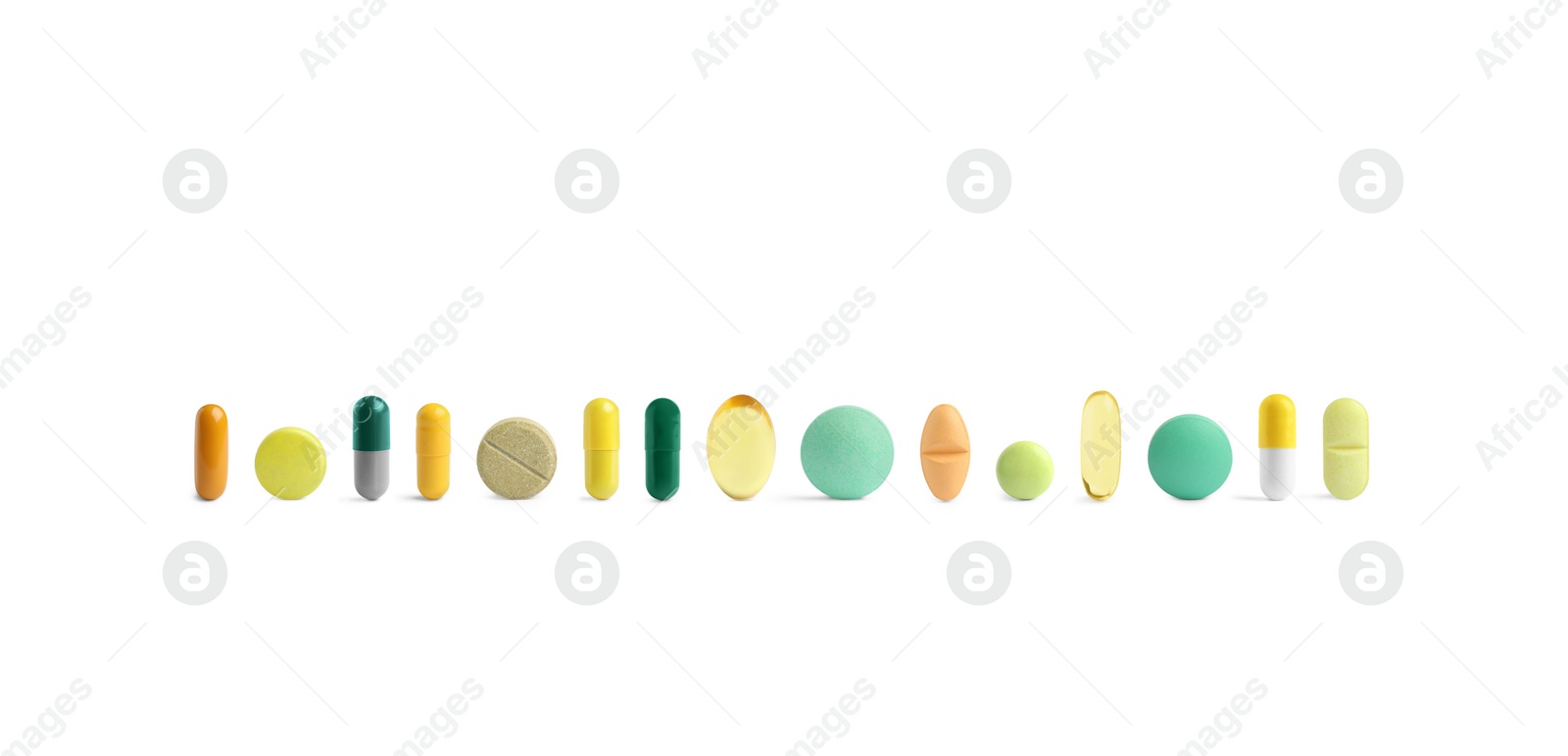 Image of Set of different color pills in row isolated on white