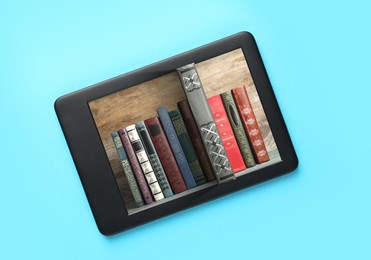 Image of Modern e-book reader on turquoise background, top view