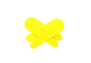 Photo of Yellow kinesio tape pieces on white background, top view