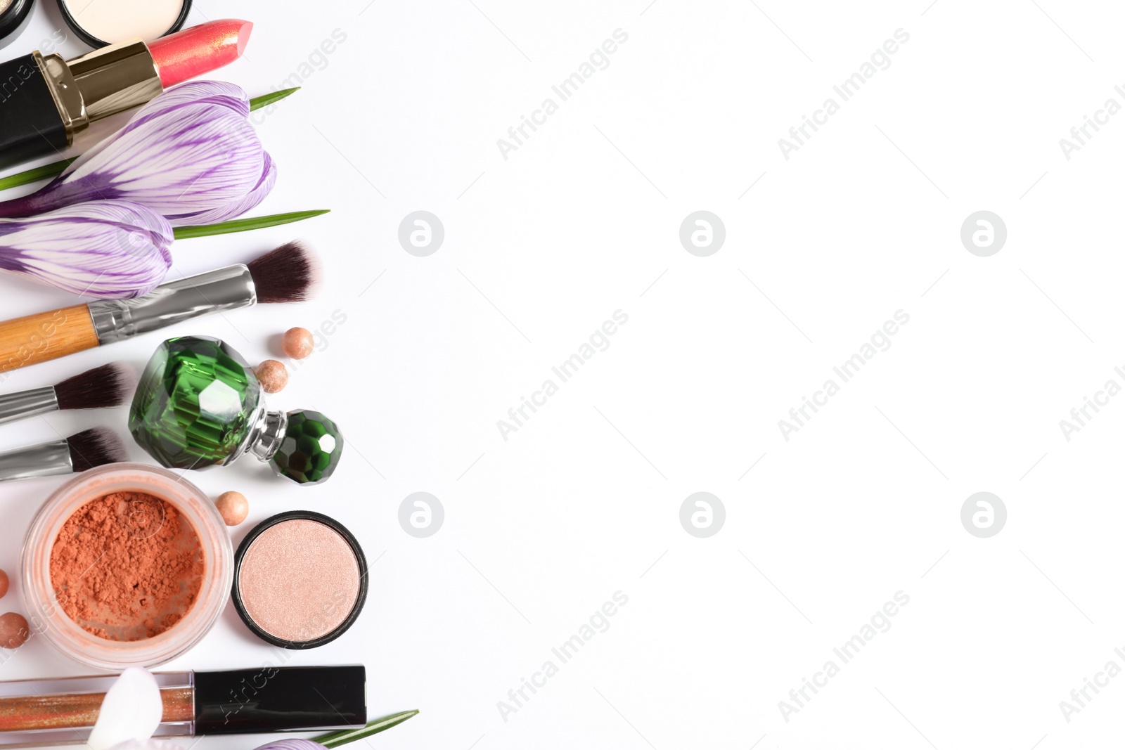 Photo of Different makeup products and flowers on white background, top view