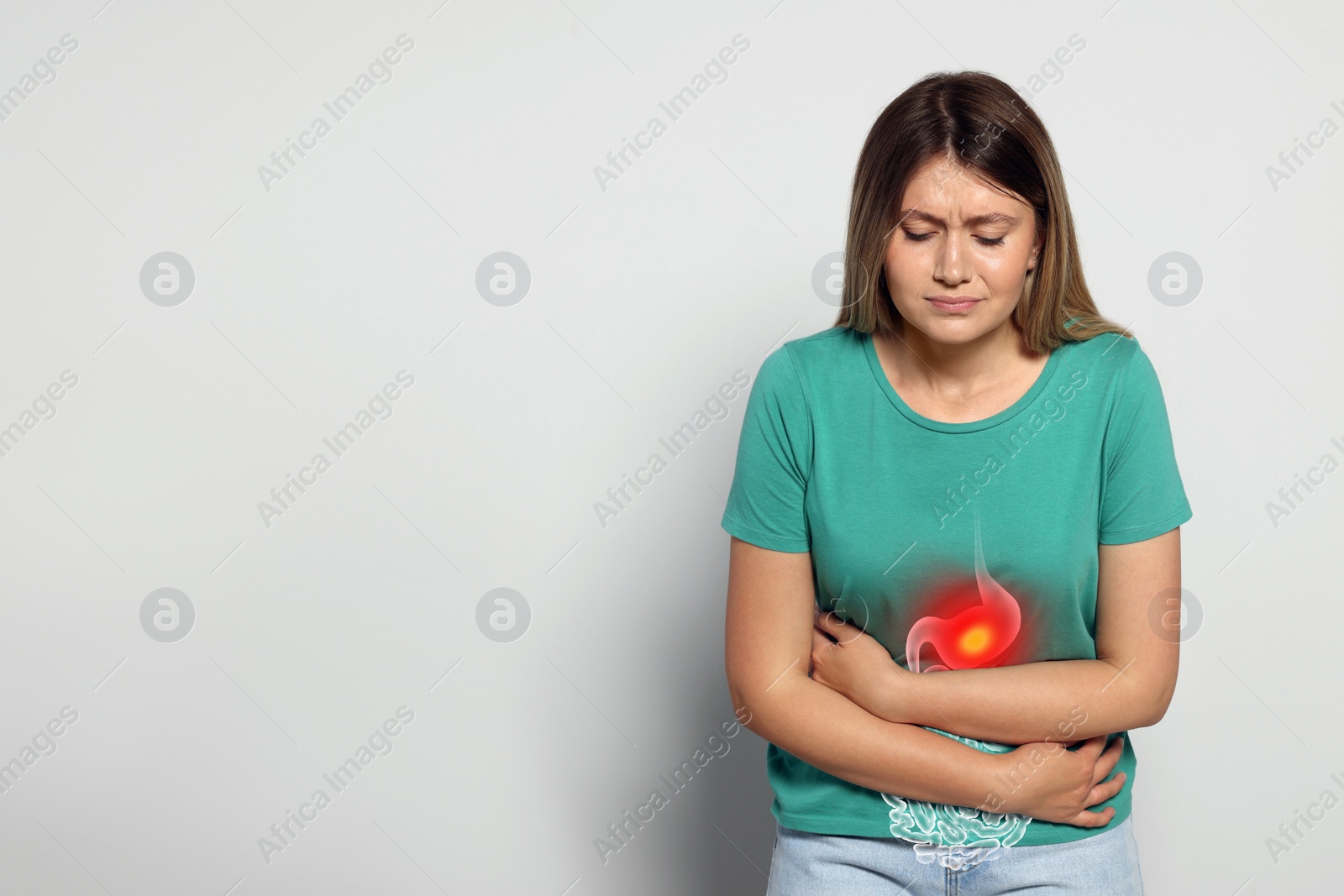 Image of Healthcare service and treatment. Woman suffering from abdominal pain on light grey background. Illustration of gastrointestinal tract