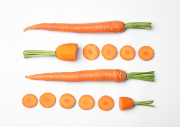 Photo of Whole and cut fresh carrots on white background