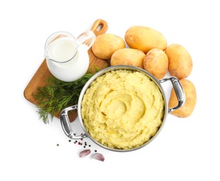 Photo of Pot of tasty mashed potatoes near ingredients on white background, top view
