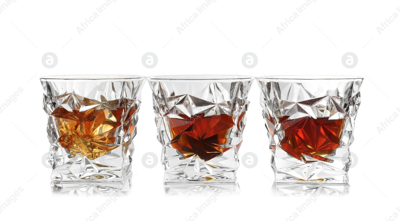 Photo of Glasses of scotch whiskey on white background