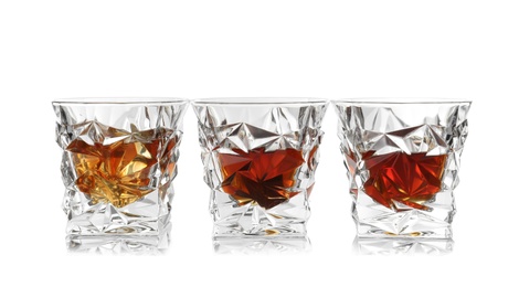 Glasses of scotch whiskey on white background