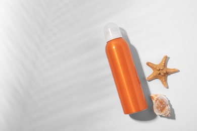 Photo of Sunscreen, starfish and seashell on white background, flat lay and space for text. Sun protection care