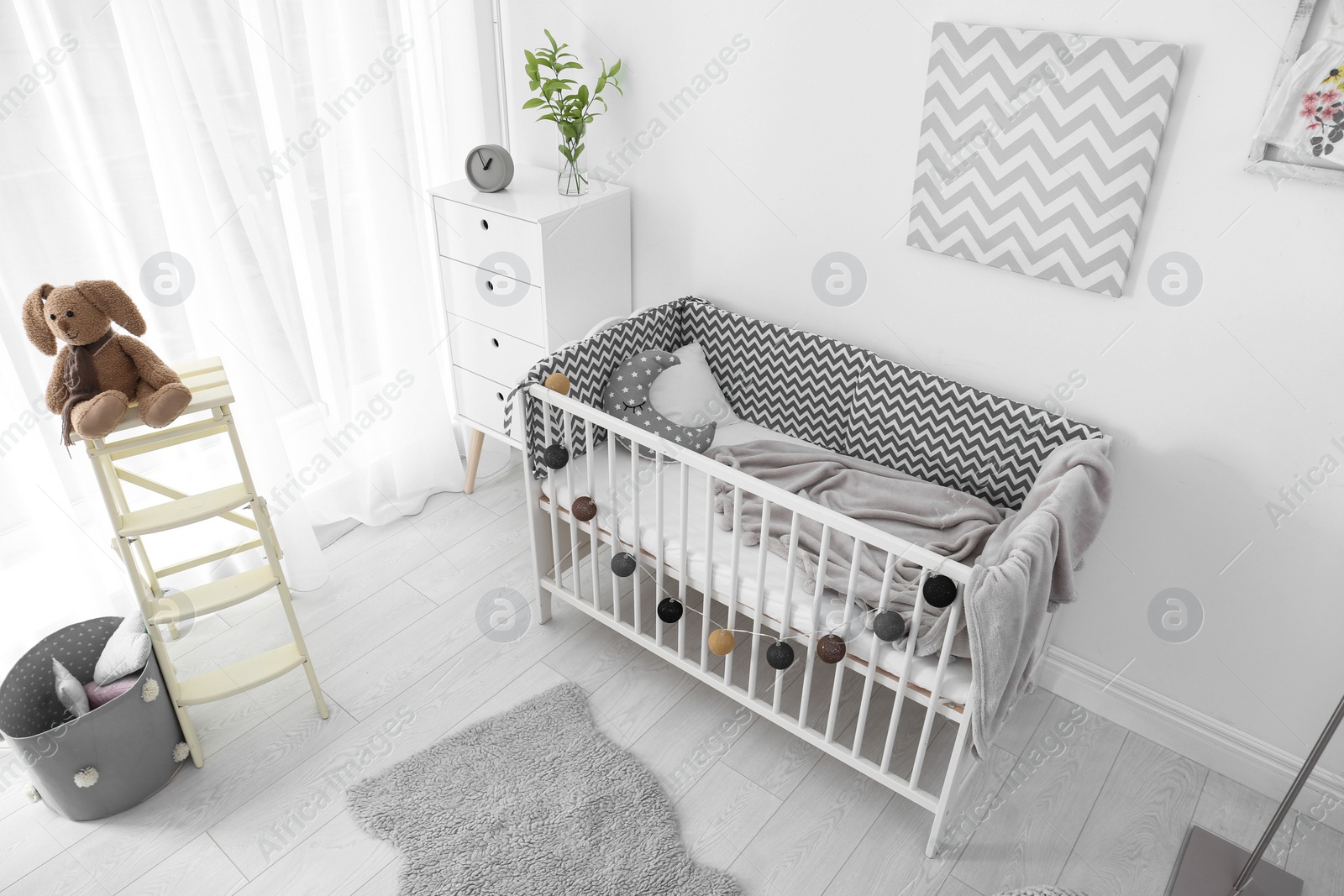 Photo of Baby room interior with comfortable crib