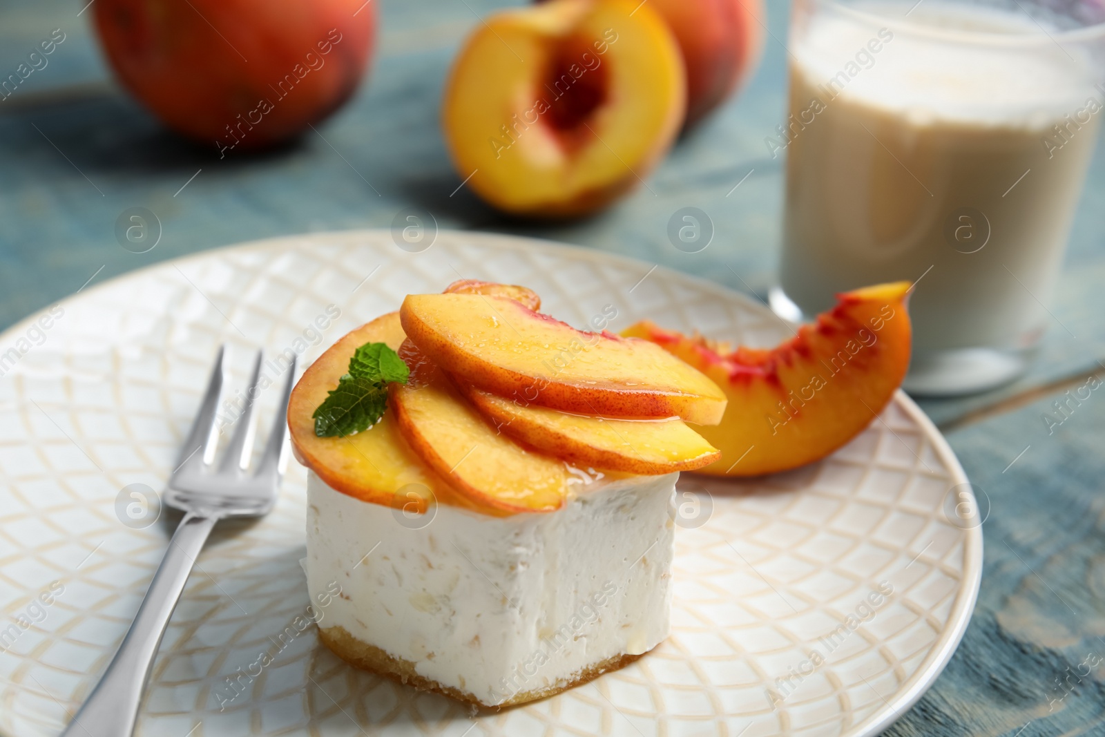 Photo of Delicious dessert with peach slices on plate, closeup