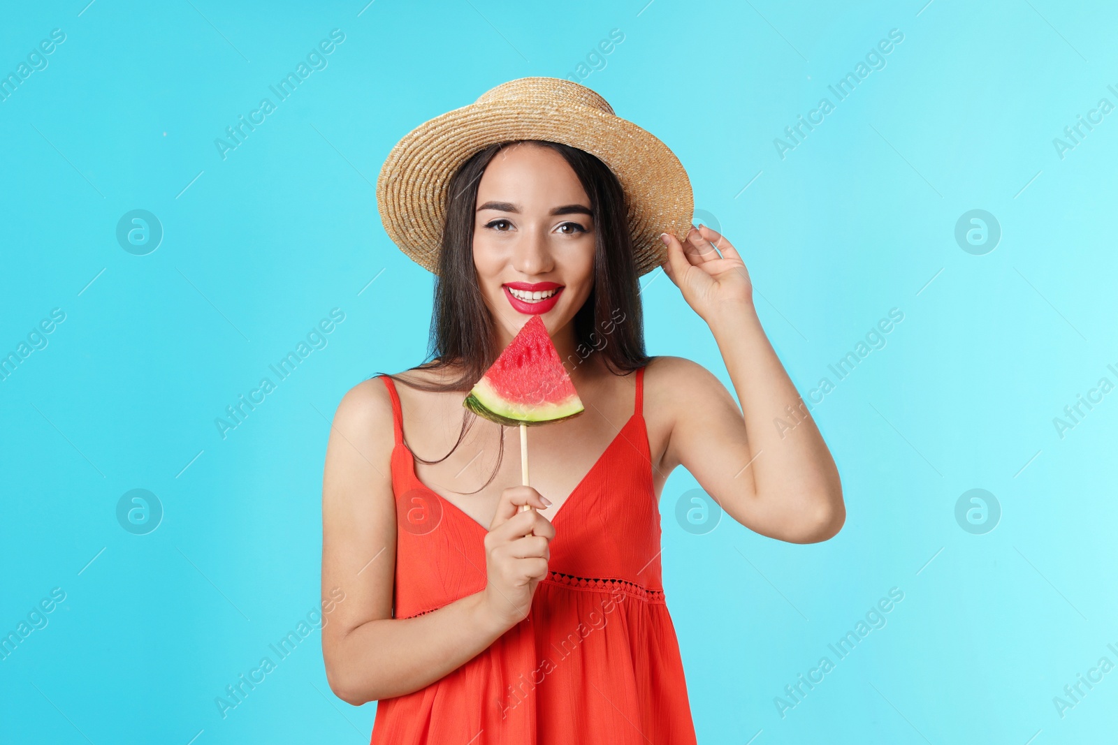 Photo of Beautiful young woman posing with watermelon on color background