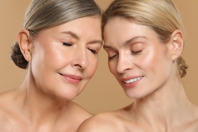 Beautiful women with healthy skin on beige background