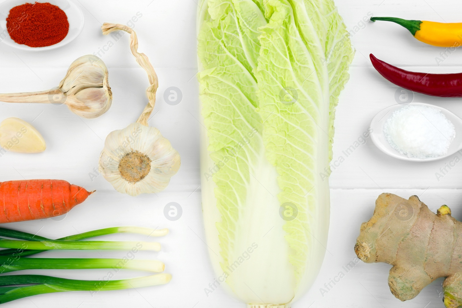 Photo of Flat lay composition with fresh Chinese cabbage and ingredients on white wooden table