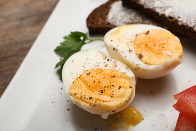 Cut soft boiled egg on plate, closeup