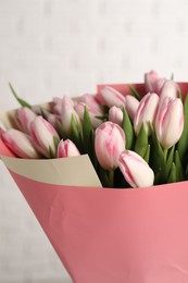 Photo of Beautiful bouquet of fresh pink tulips on light background, closeup