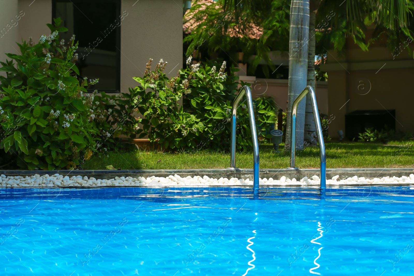 Photo of Modern swimming pool with stairs, outdoors