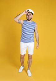 Photo of Full length portrait of sailor on yellow background