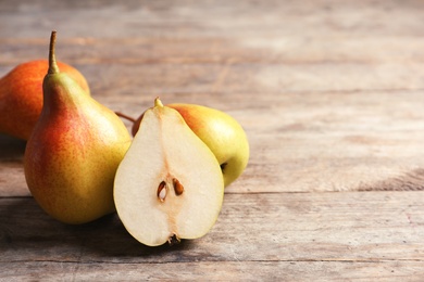 Ripe pears on wooden table. Space for text