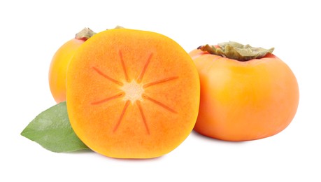 Photo of Whole and cut delicious ripe juicy persimmons on white background