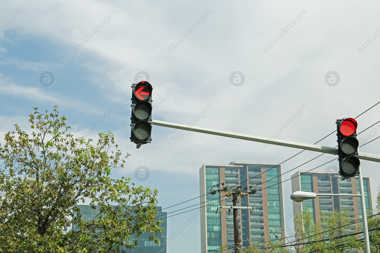 Photo of Overhead traffic lights in city. Road rules